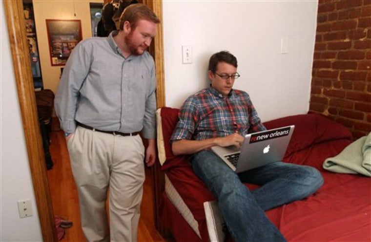 Mathew Sanders, left, and Mark Bonner pose for a photograph in the two bedroom apartment they share in New York. Census figures show that Manhattan had a dip in single-person households this past decade, despite being the capital of single living.